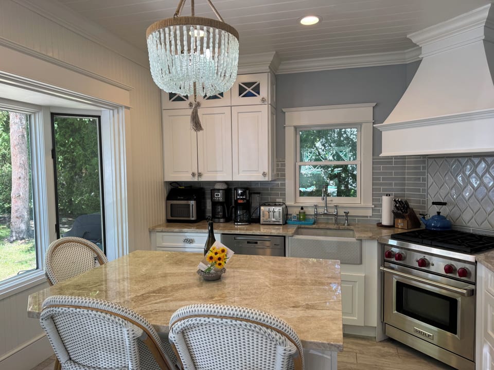 Kitchen with Wolf range and oven, harvest sink, microwave under counter, coffee