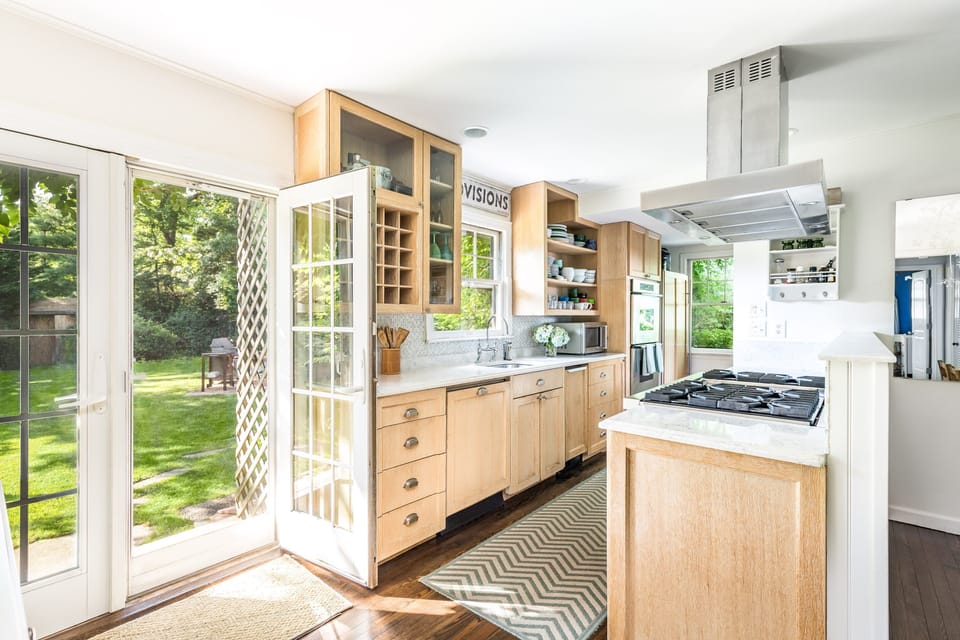 renovated kitchen with Viking stove and french doors to backyard