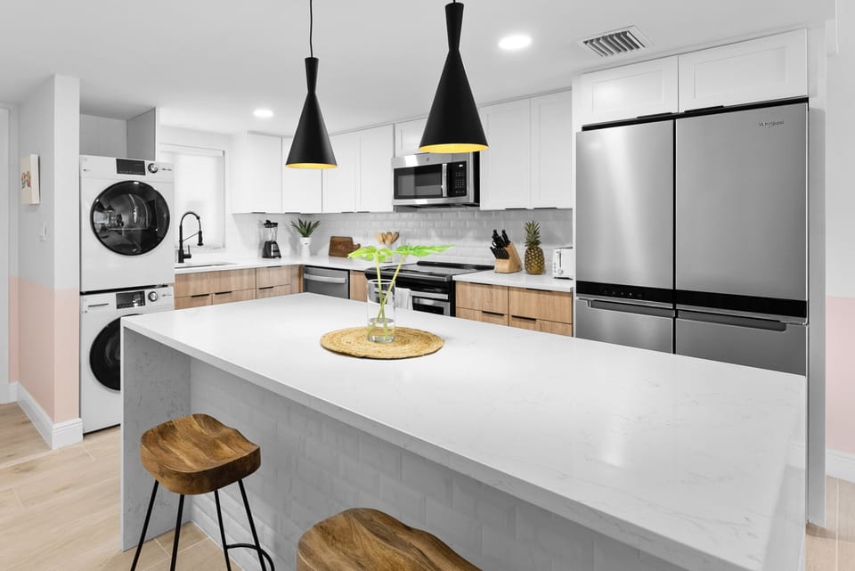 Sleek modern kitchen with elegant lighting and a spacious island for dining