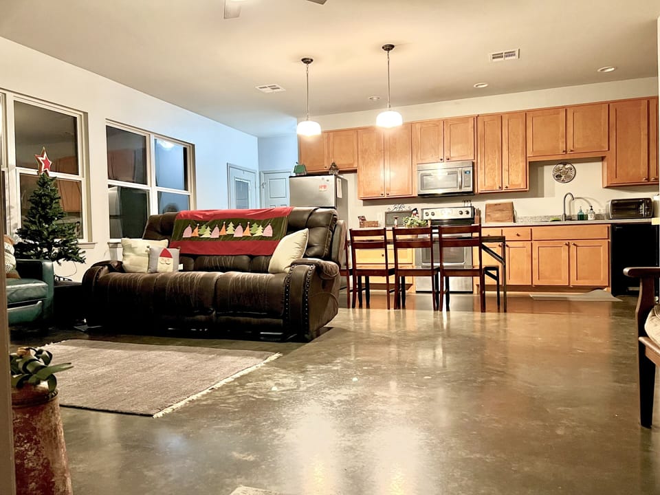 The great room allows full views of the porch and the Lake Aquilla forest