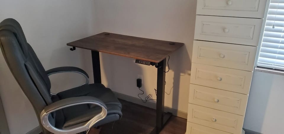 New adjustable sit/stand desk with ergonomic chair for working from home