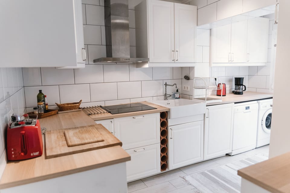 Kitchen equipped with washer, dishwasher, oven, micro and modern appliances 