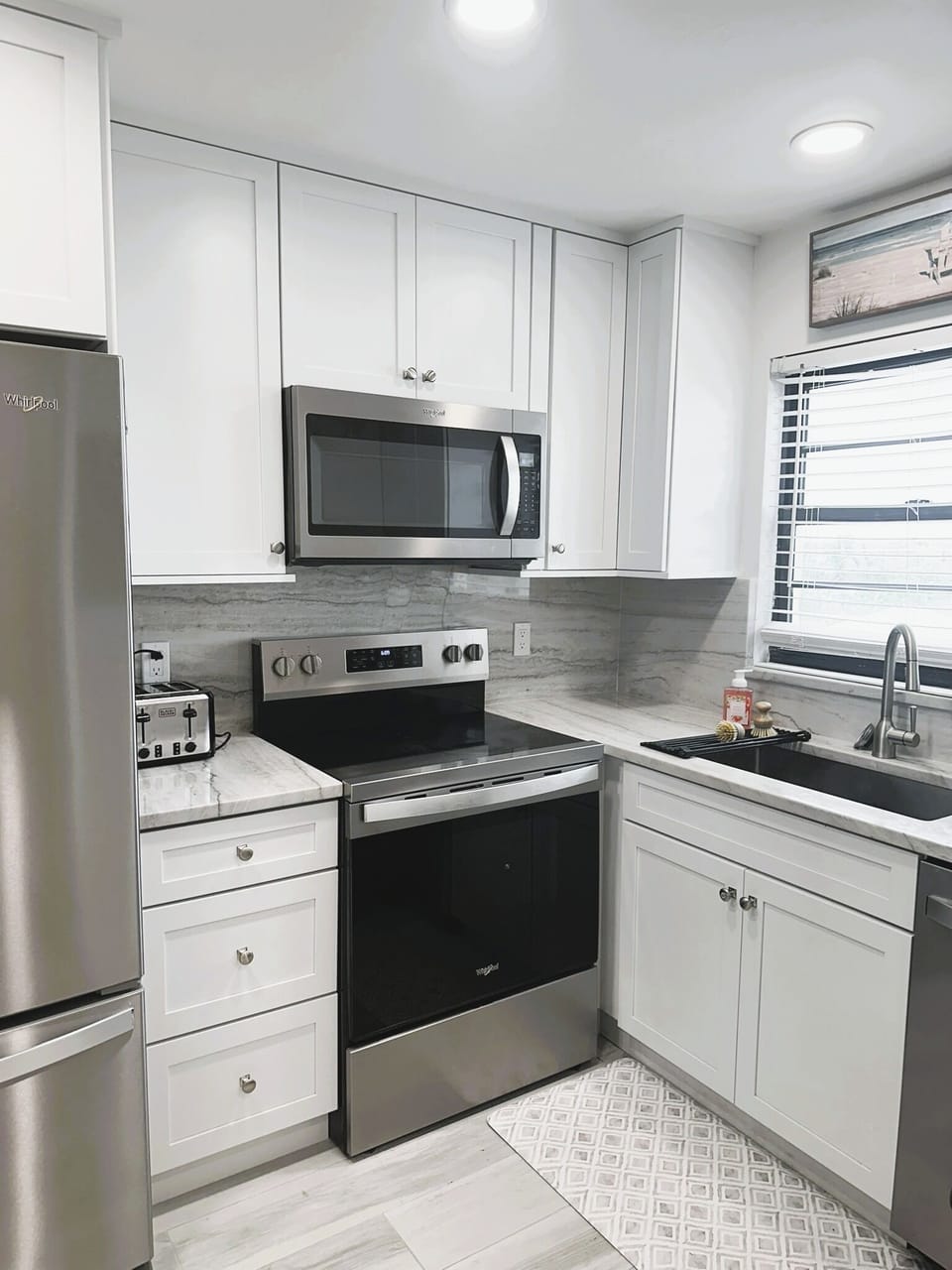 Newly renovated kitchen with all new appliances and quartz countertops.