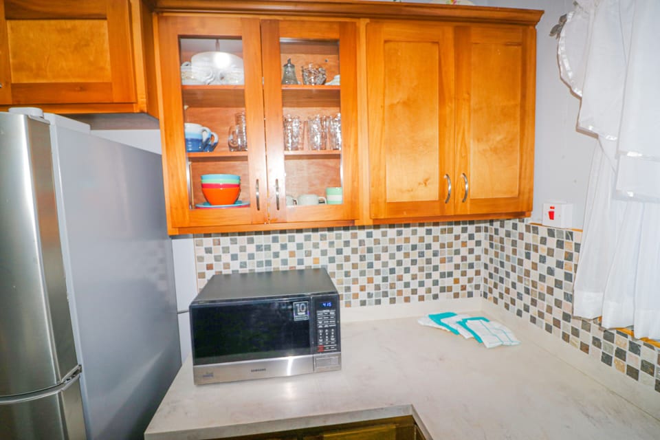 Features microwave, utensils, glass and dinnerware for your convenience.