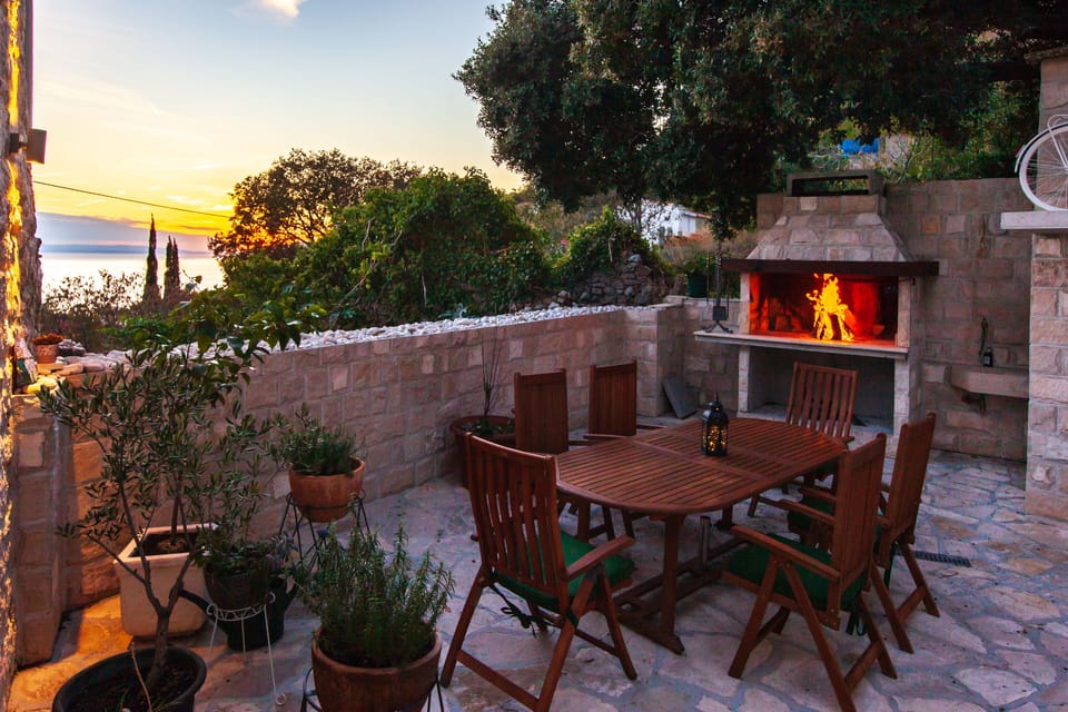 stone back yard with barbeque and kitchen
