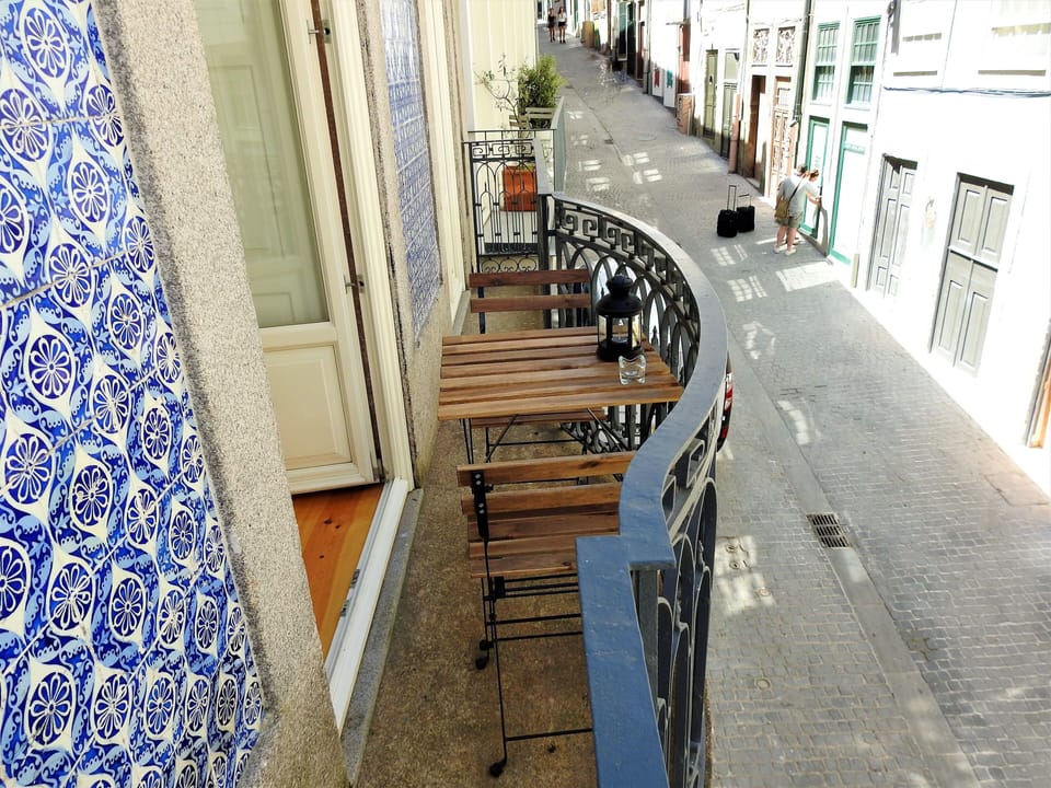 Balcony with view at Rua de Trás and torre de Clerigos.  Seating for 2