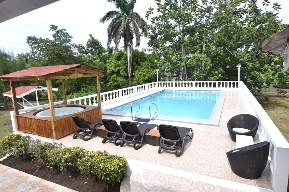 Swimming pool with spa also BBQ pit to the extreme left