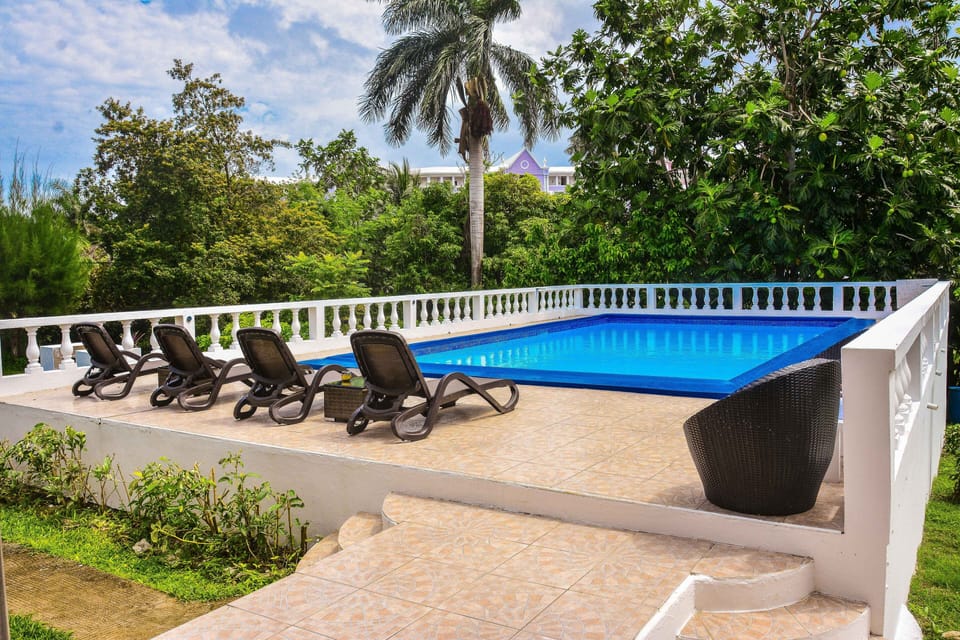 Pool area for guests of Villa Patiently Waiting which includes the Cottage