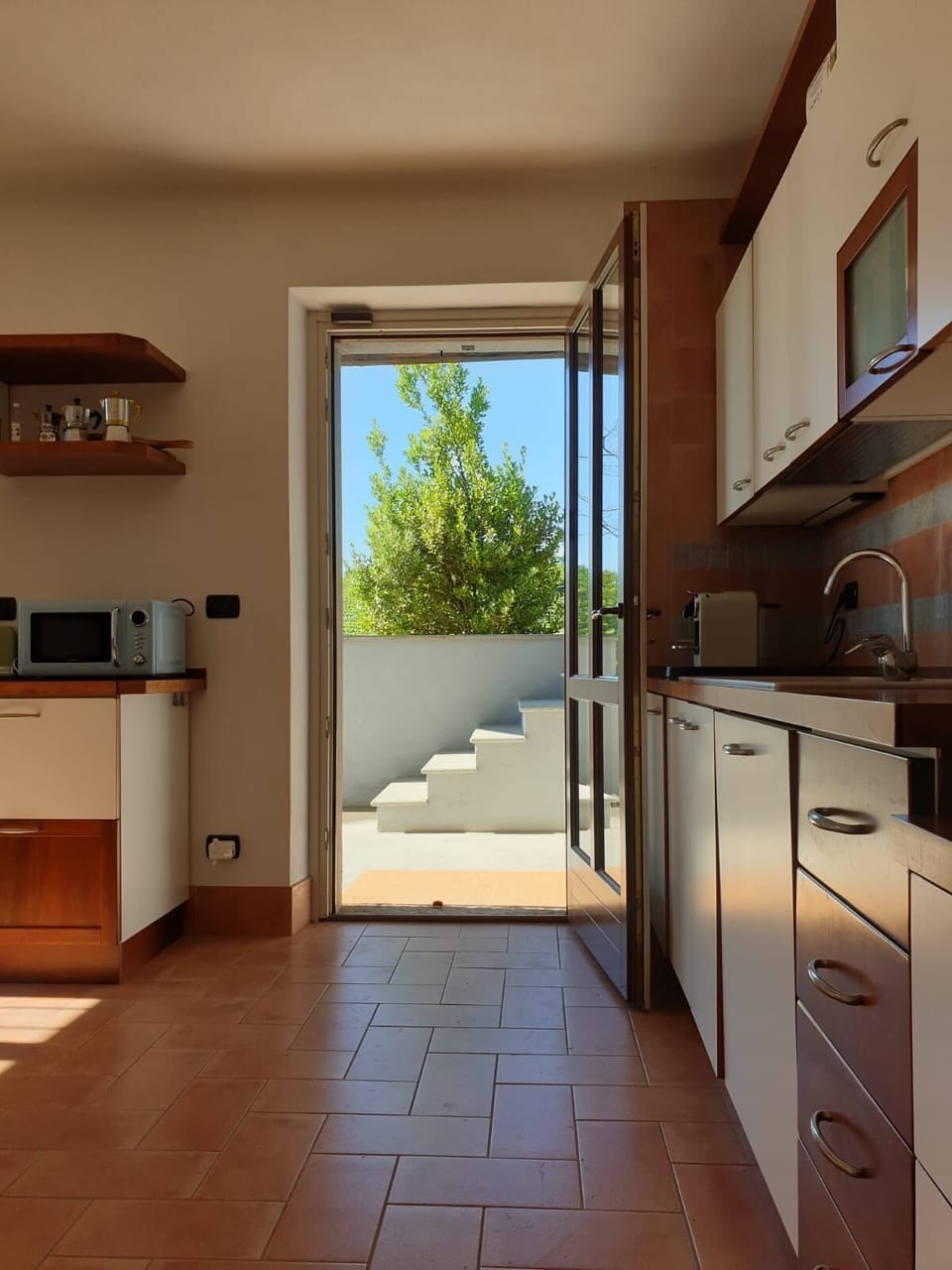 Kitchen with door to outdoor area.