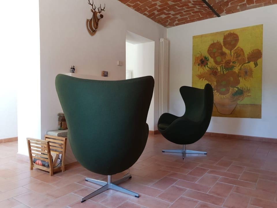 Two armchairs in front of the fireplace.