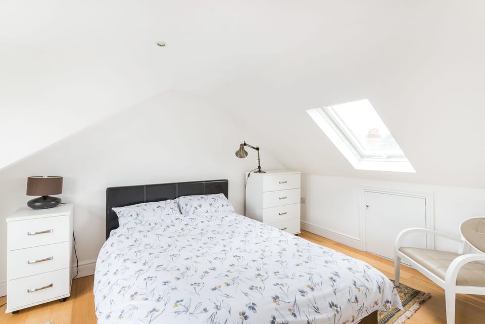 The loft double bedroom and en suite has a views  of the gardens and rooftops
