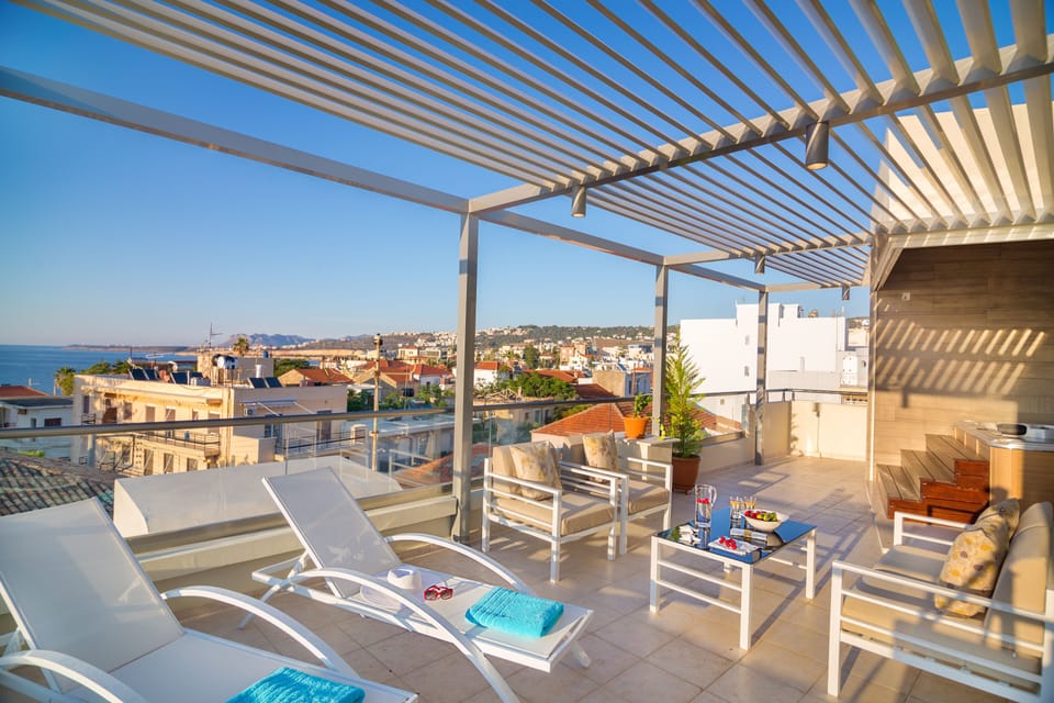 sun loungers, sofas and other casual seating under an pergola
