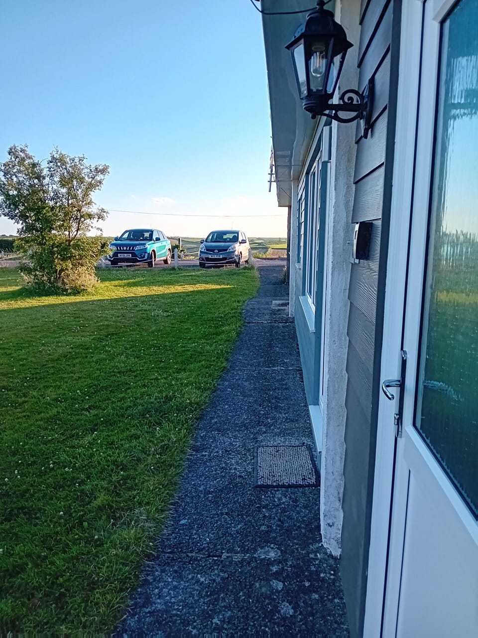 Our chalet with the wall lamp, distance to where the parking space is (blue car)