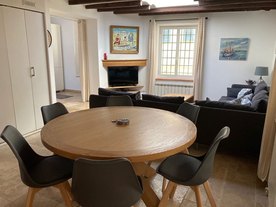 Large dining table with living area in background