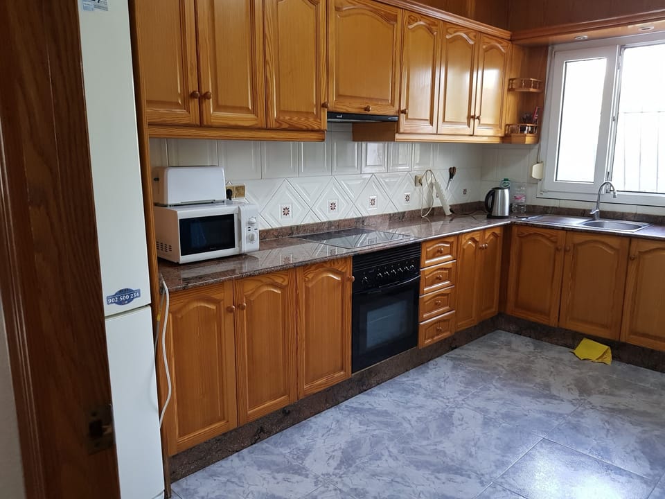  kitchen with one electric , and one gas cooker.