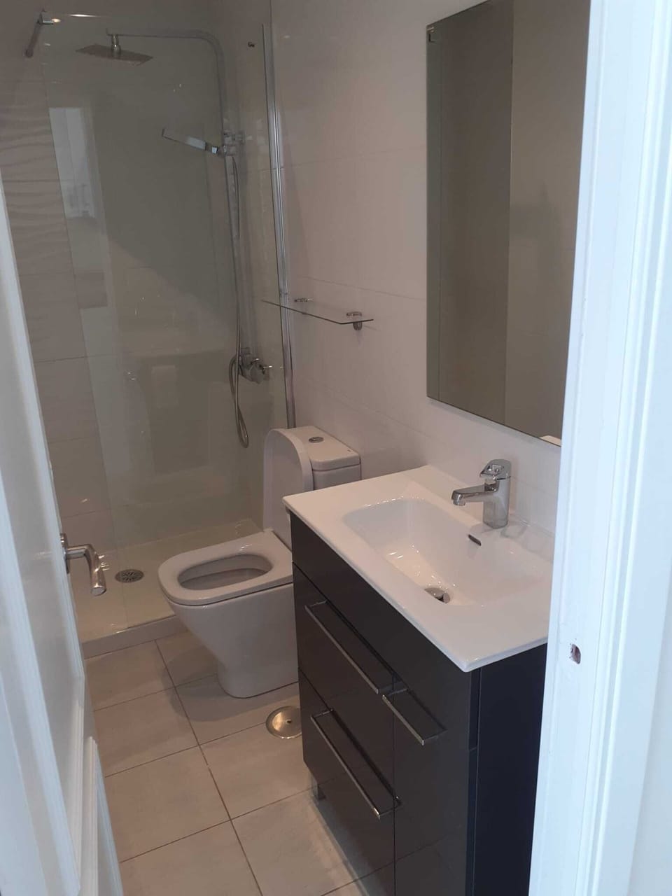 Spotless Shower Room with good storage.