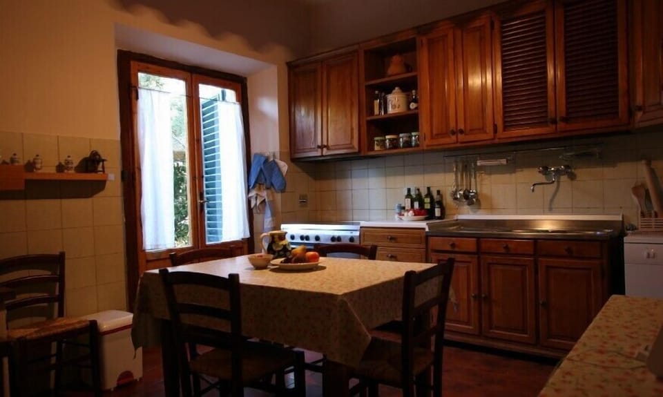 The fully furnished kitchen with the fireplace
