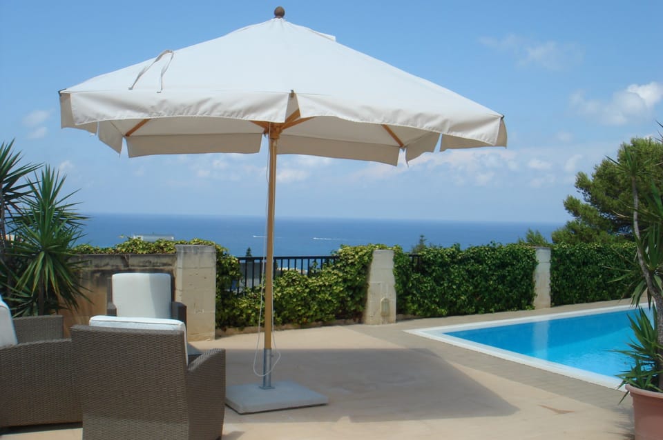 Shaded pool area with unobstructed sea and country views.