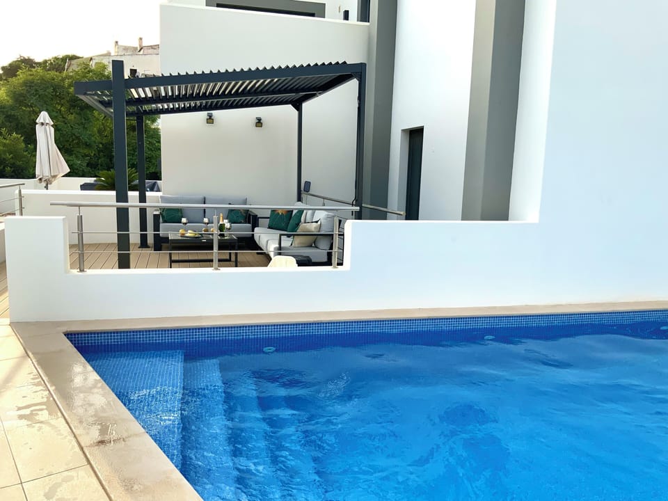 Taken from the pool showing central terrace and bedroom terrace beyond.
