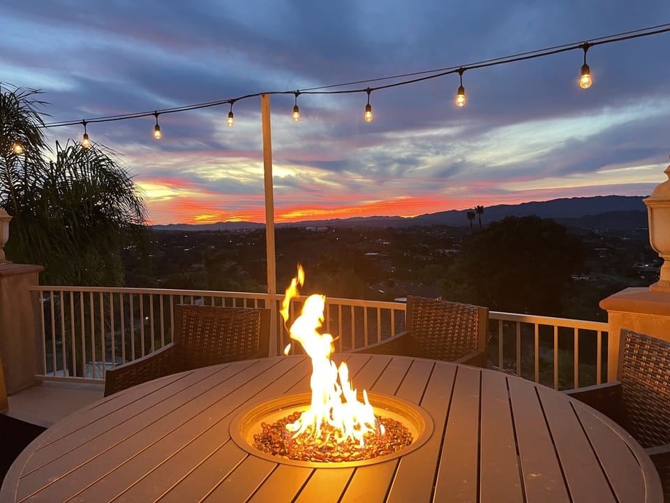 Gas fire pit w/ six comfy swivel chairs overlooking the pool, mountains, sunsets