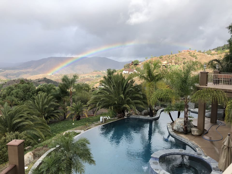 Tranquil and private salt water pool framed by a Fallbrook Rainbow