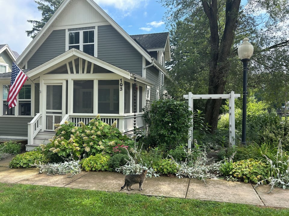 Take a stroll along the perennial filled yard and stone path along the side.