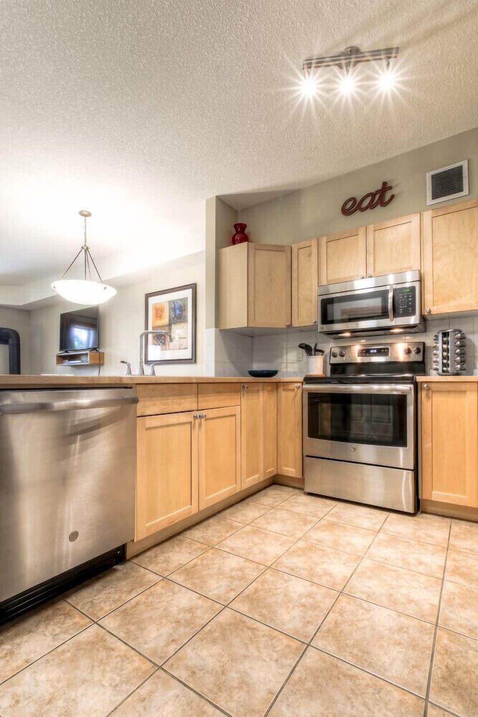 Fully Stocked Kitchen w/ Stainless Appliances Open to Dining & Living Area. 