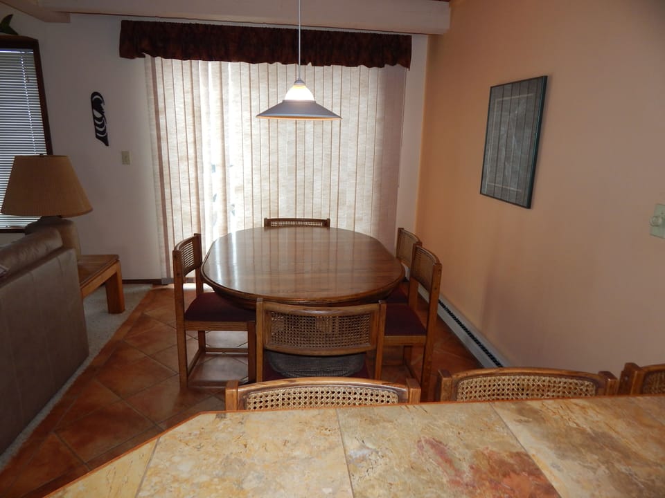 Gather around your elegant dining table for memorable meals in this warm, sunlit space with beautiful wood furnishings.