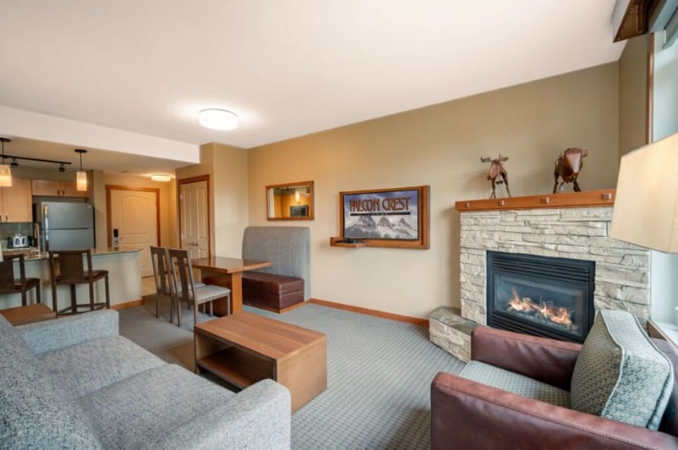 Spacious lounge area with a welcoming ambiance, offering the perfect spot to unwind by the fire.