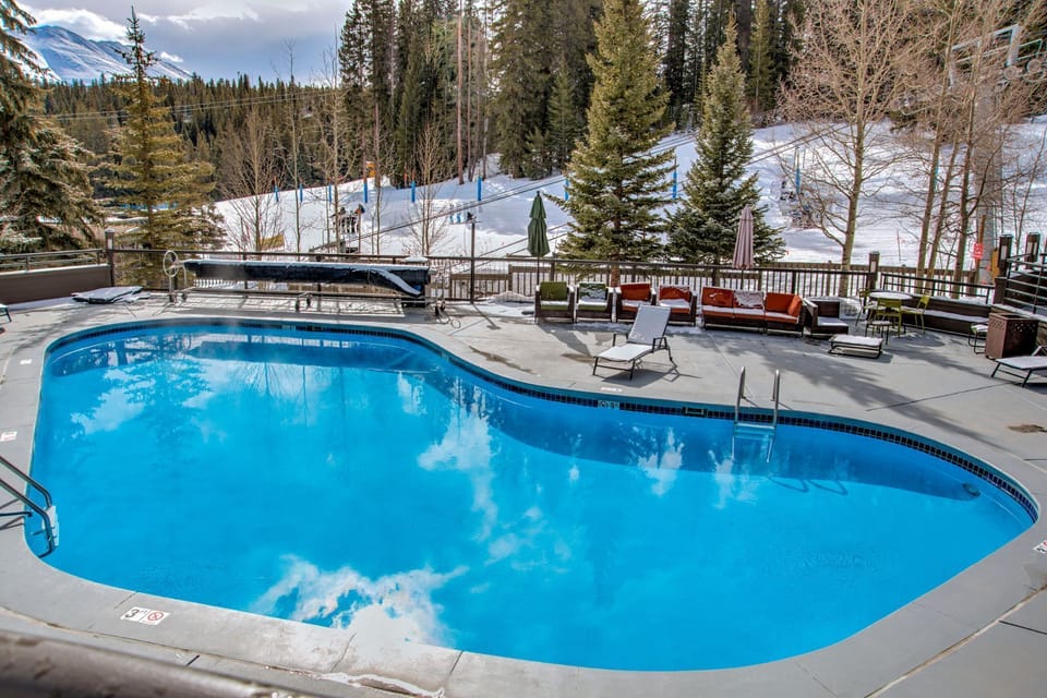 Heated outdoor pool surrounded by snow-capped views.