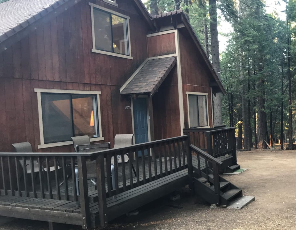 Patio set for a sunset dinner with view out to pines