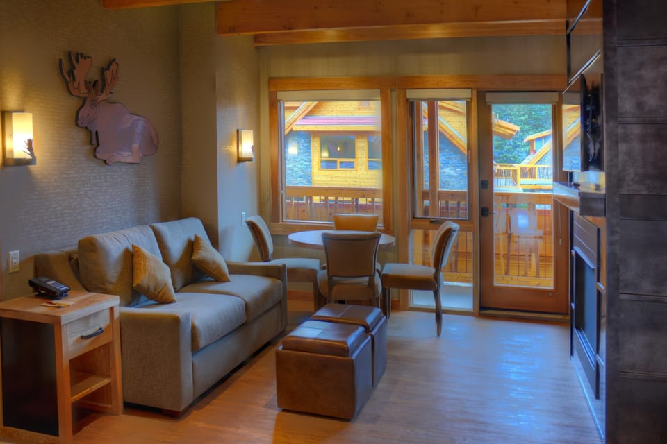 Large windows overlook the sitting area and dining table.