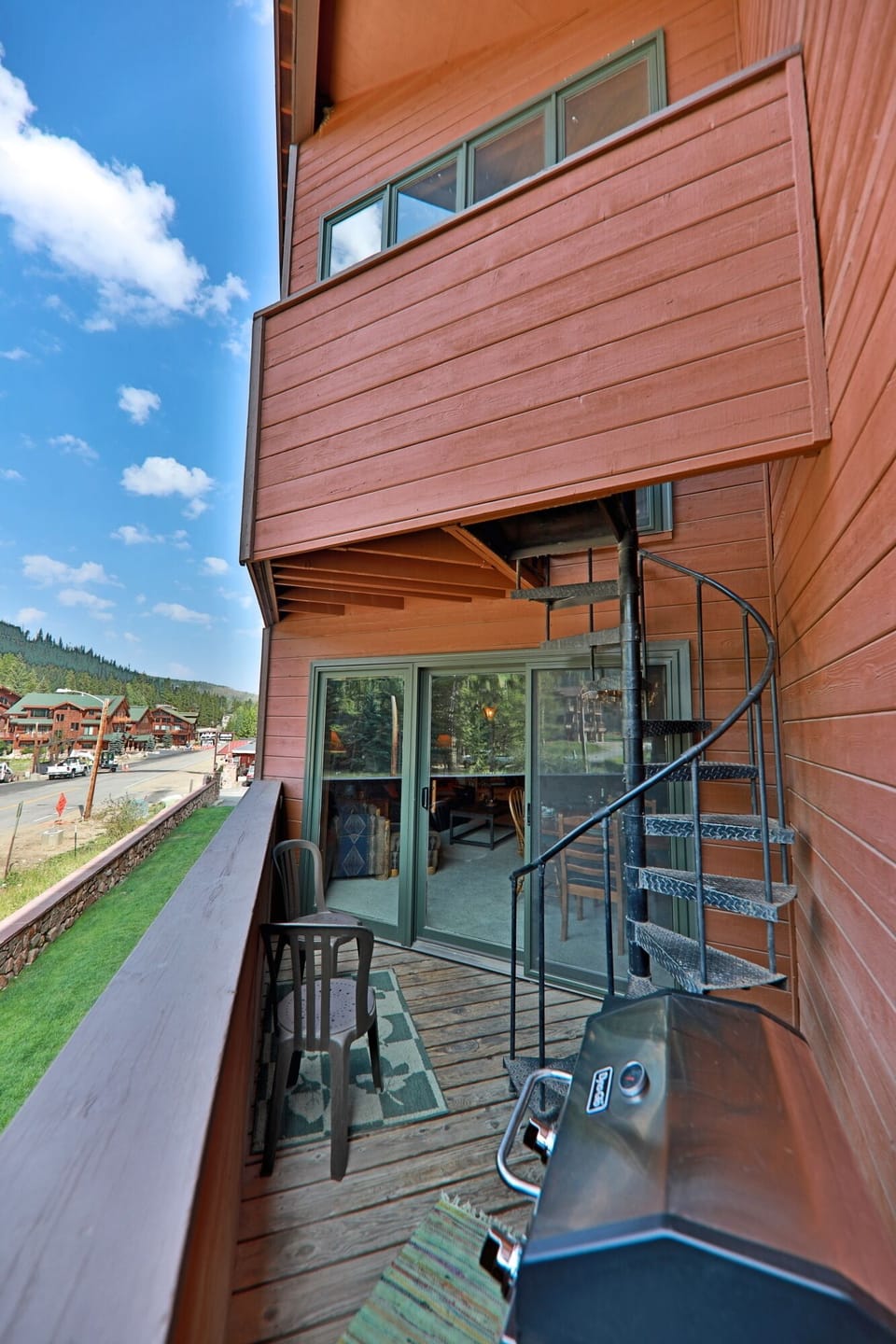 Balcony off of dining space with stairs up to master bedroom balcony