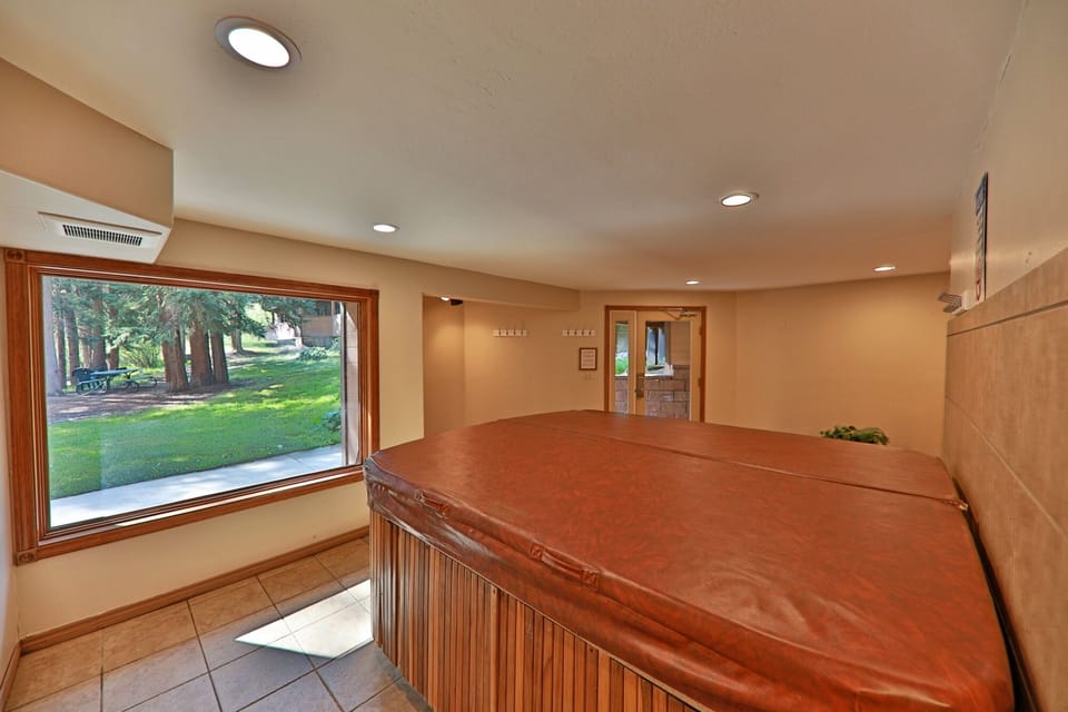 Community hot tub-located on bottom floor of condo building, housed with sauna