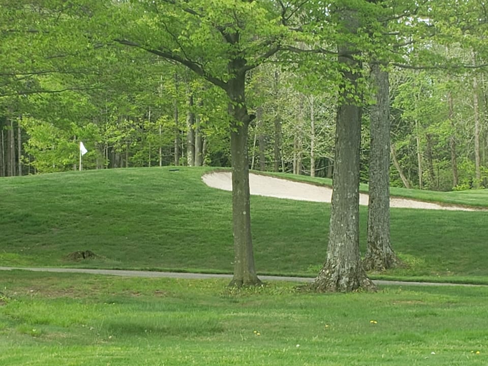 Close to the bag drop for the Upper Course and across the street from Hole 9.