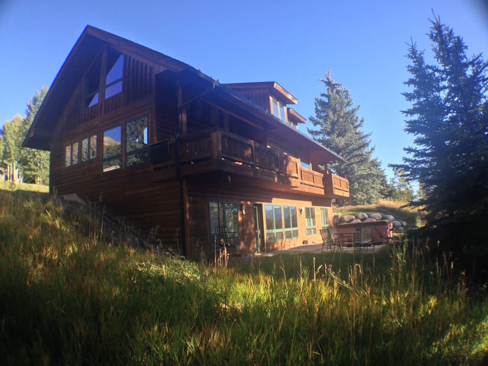 Back of the Newhard Chalet, showing deck and hot tub on patio