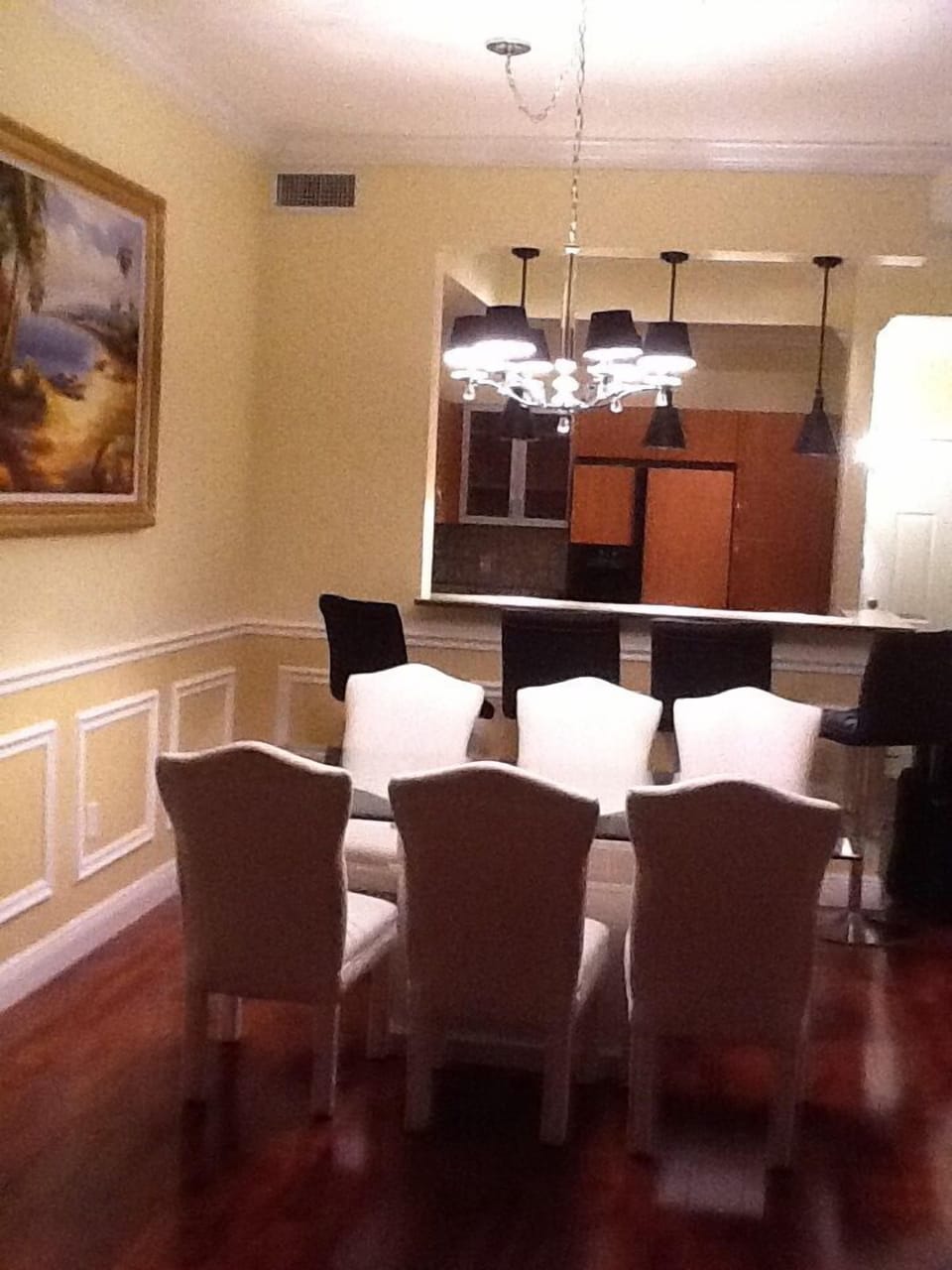 Dining area and fully equipped kitchen beyond.