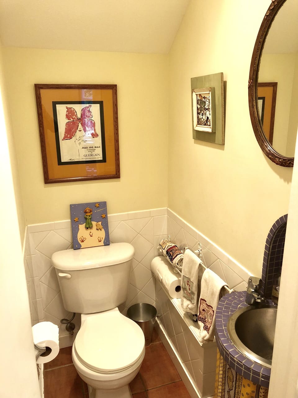 European-style toilet closet both upstairs and downstairs with lavatory + mirror
