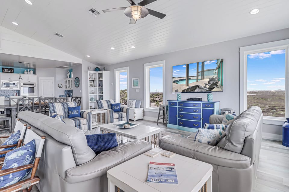 Unwind in your coastal living room where ocean views meet comfortable seating and nautical charm creates the perfect retreat.