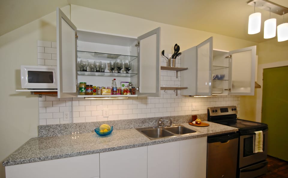 Open kitchen cabinets showing vintage glassware
