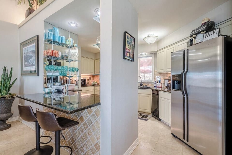 Kitchen with bar passthrough. All stainless appliances. 