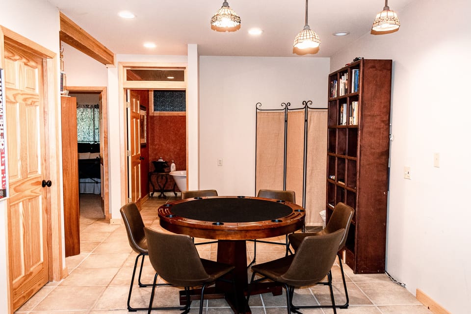 Game room with a card table, games, and a ping pong table