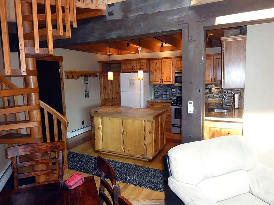 view of kitchen and staircase from living room
