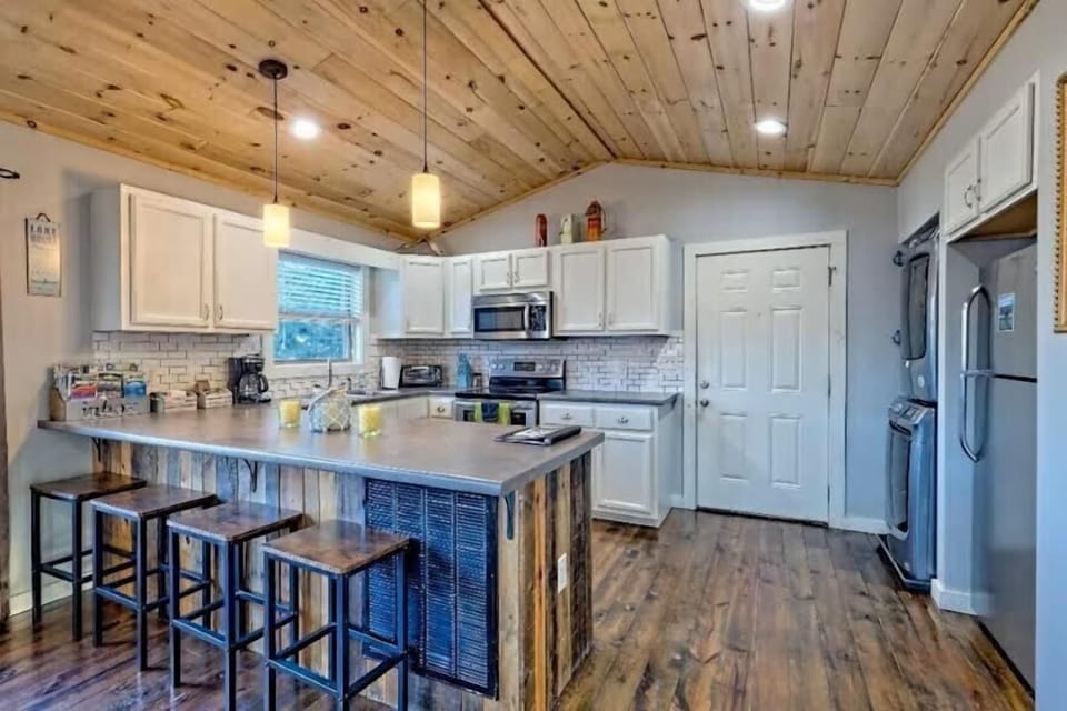 Rustic-modern kitchen with large island seating and stainless appliances