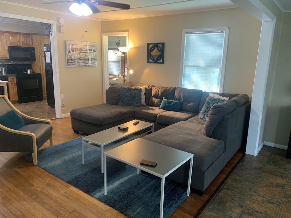 Living Room with comfortable sectional sofa is open to kitchen and foyer space.