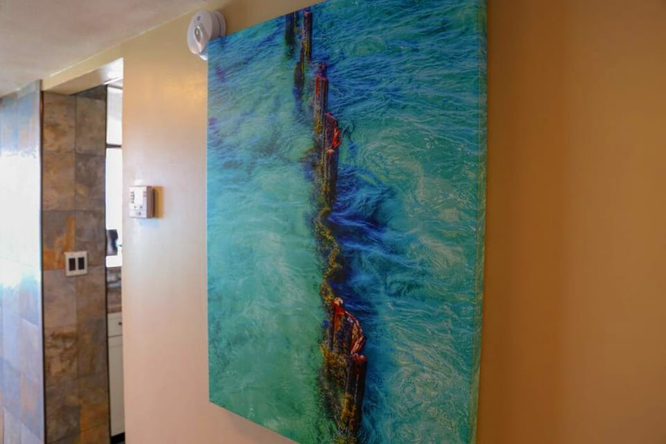 Painting in hallway leading to bedrooms