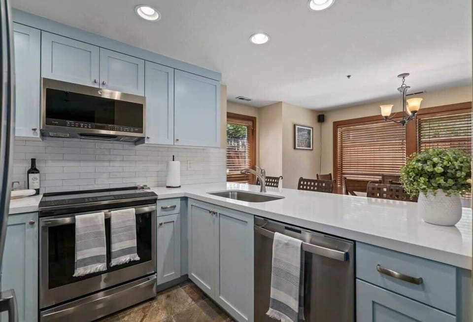 Kitchen: Sleek appliances and bright windows make this your culinary adventure hub!