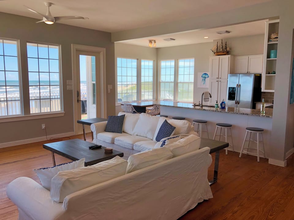 Charming panorama through walls of widows across living room and dining area.