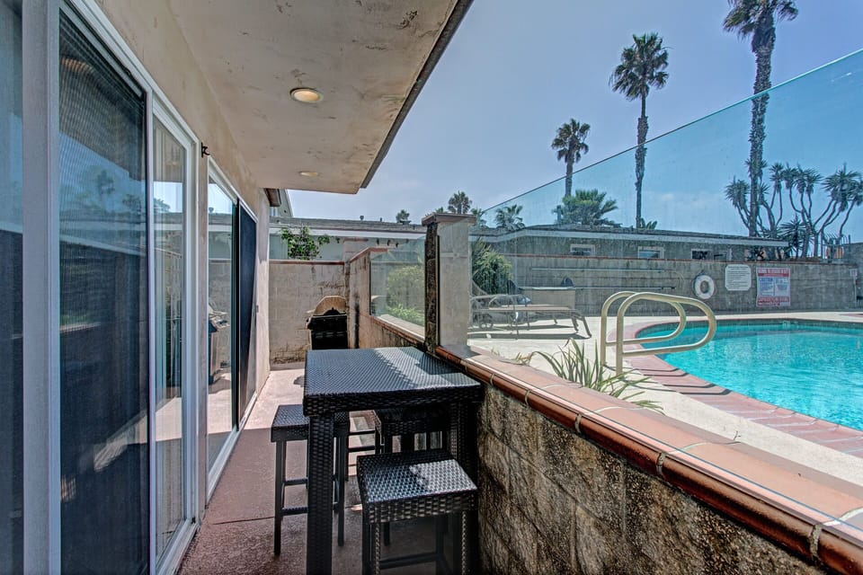 Patio view of pool with table. BBQ is no longer for use and not allowed.