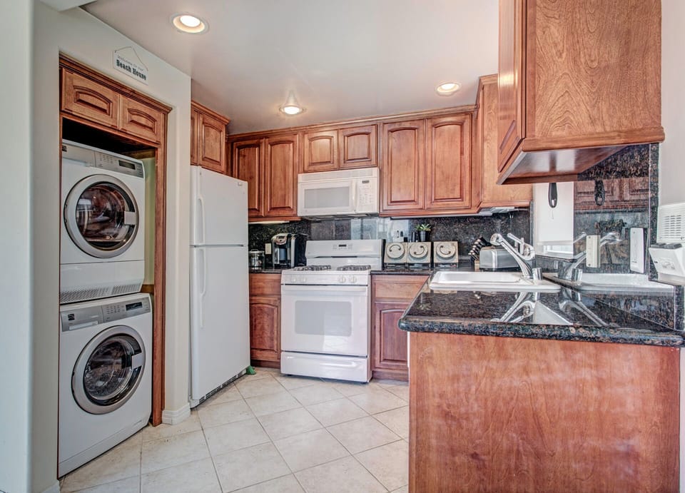 Open kitchen with stacked laundry tucked away!